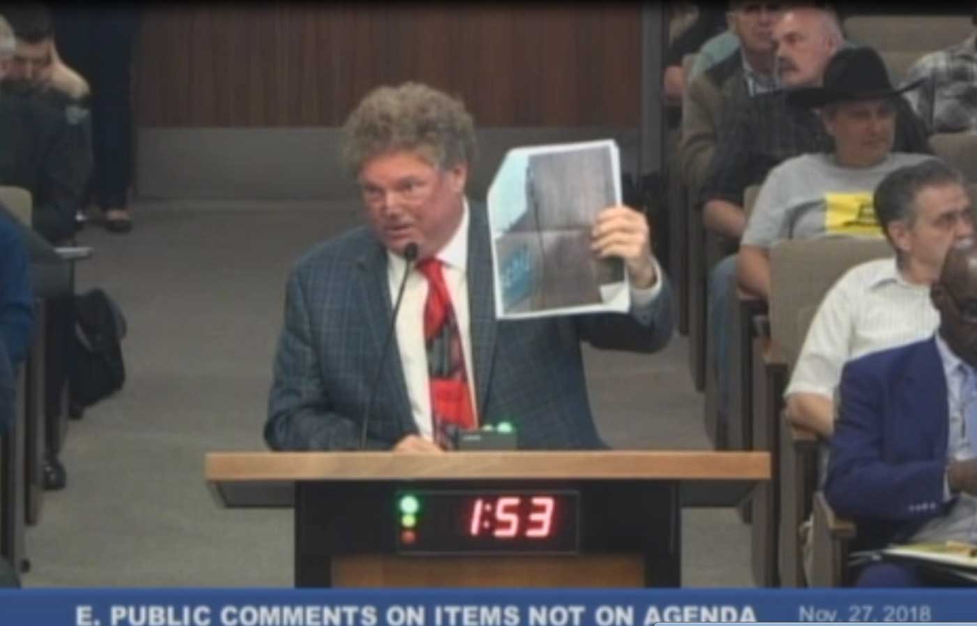 Tom Peterson presents letters and images to City Council